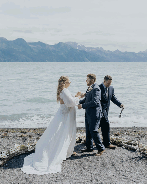 elopement couple kissing on a sunny seward alaska beach cabin wedding